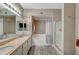 Bright bathroom featuring double sinks, a soaking tub, and separate glass-enclosed shower at 10001 Peace Way # 1321, Las Vegas, NV 89147