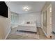 Calming bedroom with a grid accent wall, hardwood floors, and a view into the ensuite bathroom at 10001 Peace Way # 1321, Las Vegas, NV 89147
