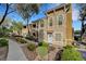 Charming multi-story home with landscaped grounds, creating a welcoming atmosphere and enhanced curb appeal at 10001 Peace Way # 1321, Las Vegas, NV 89147