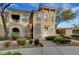 Inviting townhome with manicured landscaping, arched entry, and stylish architectural details at 10001 Peace Way # 1321, Las Vegas, NV 89147