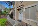 Inviting entryway with a security screen door, wreath, and well-maintained landscaping at 10001 Peace Way # 1321, Las Vegas, NV 89147