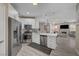Modern kitchen with stainless steel appliances, quartz countertops, and an open layout into the living area at 10001 Peace Way # 1321, Las Vegas, NV 89147