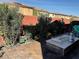Cozy brick patio with a modern fire pit and lush landscaping creating a private outdoor space at 10398 Addie De Mar Ln, Las Vegas, NV 89135