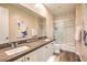 Bathroom with double sinks, modern fixtures, and a glass-enclosed shower, offering a spa-like experience at 10398 Addie De Mar Ln, Las Vegas, NV 89135