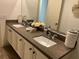 Bright bathroom featuring a double vanity with stone countertops and decorative accents at 10398 Addie De Mar Ln, Las Vegas, NV 89135