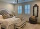 Inviting primary bedroom featuring a plush bed, neutral tones, and charming decor, enhanced by natural light at 10398 Addie De Mar Ln, Las Vegas, NV 89135
