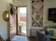 Bright and inviting foyer with a decorative wreath, stylish shelving, and a comfortable armchair at 10398 Addie De Mar Ln, Las Vegas, NV 89135