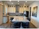 Modern kitchen featuring an island with seating, stainless steel appliances, and chic backsplash at 10398 Addie De Mar Ln, Las Vegas, NV 89135