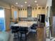 Elegant kitchen with a central island, modern appliances, and a view of the backyard at 10398 Addie De Mar Ln, Las Vegas, NV 89135