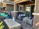 Cozy patio with an outdoor seating area, fire pit and neutral color palette at 10398 Addie De Mar Ln, Las Vegas, NV 89135