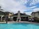 Beautiful pool area with comfortable seating, shade structures, and well-kept landscaping, perfect for recreation at 10398 Addie De Mar Ln, Las Vegas, NV 89135