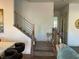 Modern staircase with wooden steps and metal railings, complemented by stylish decor and natural light at 10398 Addie De Mar Ln, Las Vegas, NV 89135