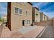 A view of the home's backyard with a small paved area and gravel landscaping at 105 Campbelltown Ave, Henderson, NV 89015
