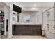 Bright bathroom with an over-sized mirror, a double vanity, and tub-shower combo at 105 Campbelltown Ave, Henderson, NV 89015