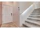 Bright entryway with a carpeted staircase and a front door with a digital lock at 105 Campbelltown Ave, Henderson, NV 89015