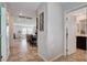 Hallway leading to open kitchen with bar seating, tile floors and a view of the bathroom at 105 Campbelltown Ave, Henderson, NV 89015