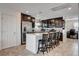 Beautiful kitchen with stainless steel appliances, dark cabinets, tile floor, and large center island at 105 Campbelltown Ave, Henderson, NV 89015