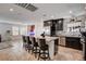 Bright open kitchen features stainless appliances, granite counters, tile flooring and a large island with seating at 105 Campbelltown Ave, Henderson, NV 89015