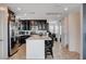 Open kitchen with stainless steel appliances, granite counters, and a large island with bar seating at 105 Campbelltown Ave, Henderson, NV 89015