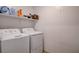 Functional laundry room with a white washer, dryer, and storage shelf at 105 Campbelltown Ave, Henderson, NV 89015