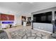 Bright living room featuring an electric fireplace, comfortable seating, and an open layout to the kitchen at 105 Campbelltown Ave, Henderson, NV 89015