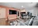 Open living room featuring hardwood floors, a modern sofa, and large windows at 105 Campbelltown Ave, Henderson, NV 89015