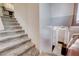 Carpeted staircase with a window and an entry to the basement or a lower level at 105 Campbelltown Ave, Henderson, NV 89015