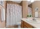 This full bathroom features decorative accents and a shower with curtain at 10748 Aldrovandi Dr, Las Vegas, NV 89141