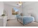 Bright bedroom featuring a canopy bed and a large window with a picturesque view at 10748 Aldrovandi Dr, Las Vegas, NV 89141