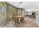 Open dining area with large windows showcasing backyard views and natural light at 10748 Aldrovandi Dr, Las Vegas, NV 89141