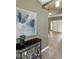 Foyer featuring neutral walls, tile flooring, and a stylish table with plants, with a view to the second floor at 10748 Aldrovandi Dr, Las Vegas, NV 89141