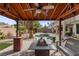Backyard gazebo with seating area and fire pit overlooking the pool at 10748 Aldrovandi Dr, Las Vegas, NV 89141