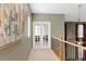 Hallway featuring an art decor, iron railings, and a glass french door entryway at 10748 Aldrovandi Dr, Las Vegas, NV 89141