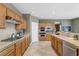 Spacious kitchen with oak cabinets, stainless appliances, tile flooring and countertops at 10748 Aldrovandi Dr, Las Vegas, NV 89141
