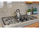 Granite counters and stainless steel gas cooktop make this kitchen ideal for gourmet meals at 10748 Aldrovandi Dr, Las Vegas, NV 89141