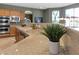 Bright kitchen featuring stainless steel appliances, light countertops, and a breakfast bar at 10748 Aldrovandi Dr, Las Vegas, NV 89141