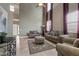 Bright living room with high ceilings, neutral walls, tile flooring, and stylish, comfortable furniture at 10748 Aldrovandi Dr, Las Vegas, NV 89141