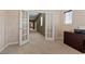 Bright office space with ample storage, a view of the hallway, and lots of natural light at 10748 Aldrovandi Dr, Las Vegas, NV 89141