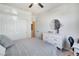 Bedroom features a closet, dresser, round mirror, and a soft, inviting bed at 10847 Intro Ave, Las Vegas, NV 89135