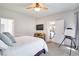 Bright bedroom with a ceiling fan, TV and a door leading to the kitchen at 10847 Intro Ave, Las Vegas, NV 89135