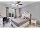 Cozy bedroom with a neutral color scheme, large window letting in natural light, and modern decor at 10847 Intro Ave, Las Vegas, NV 89135