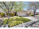 Charming single-story home with a well-manicured lawn, desert landscaping, and a two-car garage at 10847 Intro Ave, Las Vegas, NV 89135