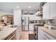 Well-equipped kitchen featuring stainless steel appliances, white cabinetry, and a tile backsplash at 10847 Intro Ave, Las Vegas, NV 89135