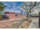 A backyard view shows rock landscaping, a cozy yard, and mature trees in the yard at 1113 Date St, Las Vegas, NV 89108