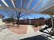 Backyard shows rock landscaping and a playground under a pergola in a comfortable setting at 1113 Date St, Las Vegas, NV 89108