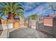 The backyard features unfinished cinder block walls, gravel, a mature palm tree, and concrete slabs at 1113 Date St, Las Vegas, NV 89108