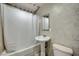 Bathroom features tile flooring, toilet, pedestal sink and shower at 1113 Date St, Las Vegas, NV 89108