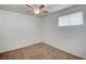 This bedroom features brown carpet, white walls, ceiling fan, and a bright window at 1113 Date St, Las Vegas, NV 89108