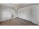 Bedroom with neutral carpet, white walls, ceiling fan, and ensuite access to a grey toned bathroom at 1113 Date St, Las Vegas, NV 89108