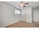 Neutral bedroom with brown carpet, white walls, ceiling fan, and natural light from window at 1113 Date St, Las Vegas, NV 89108